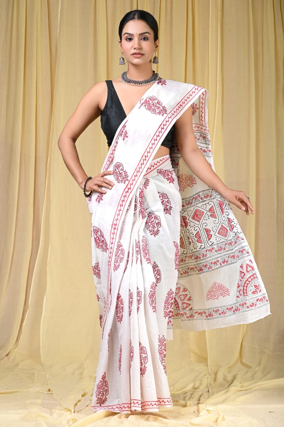 White saree with red floral block print and geometric border design