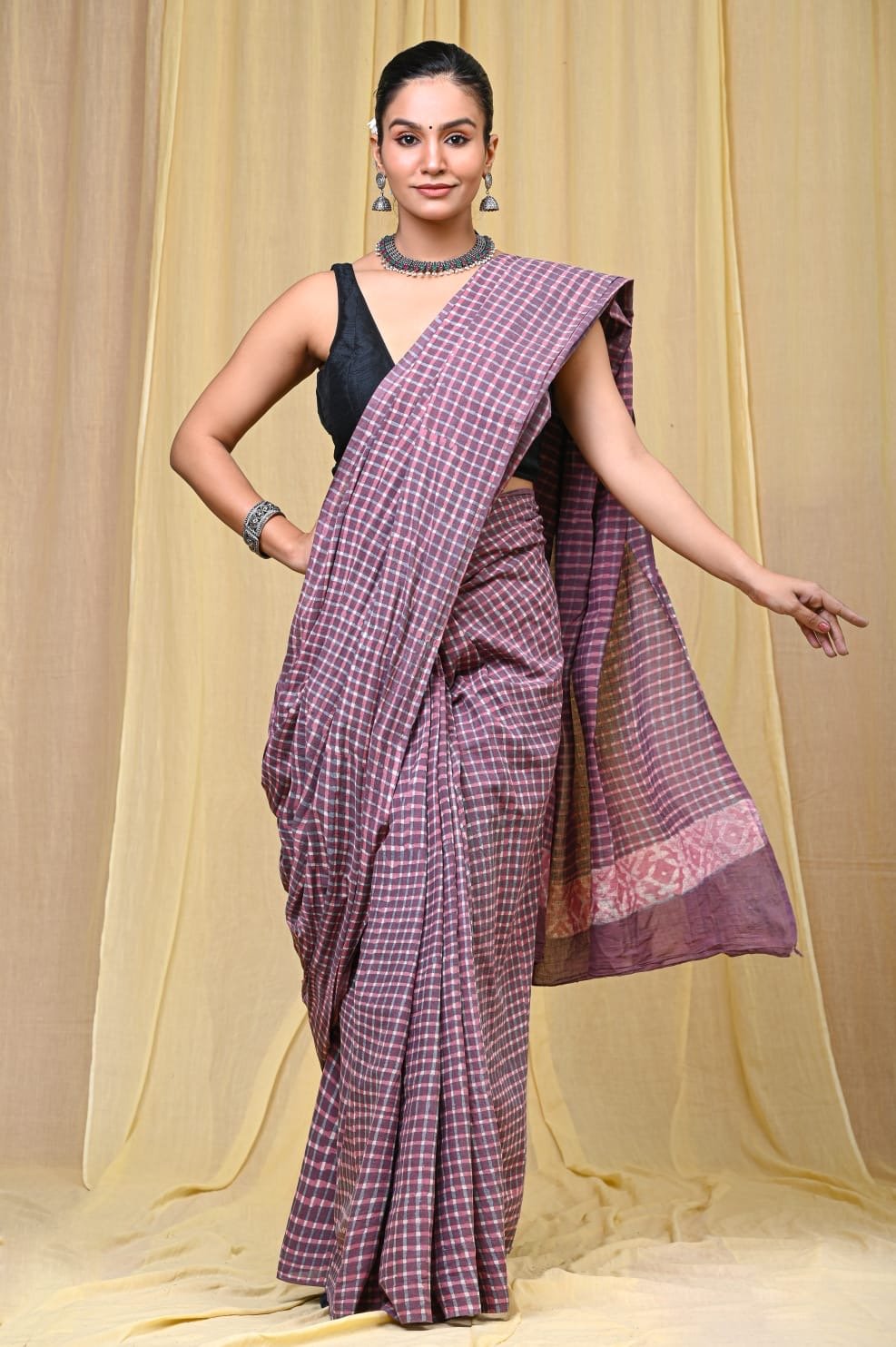 Purple checkered saree with white motifs and traditional Bagru design