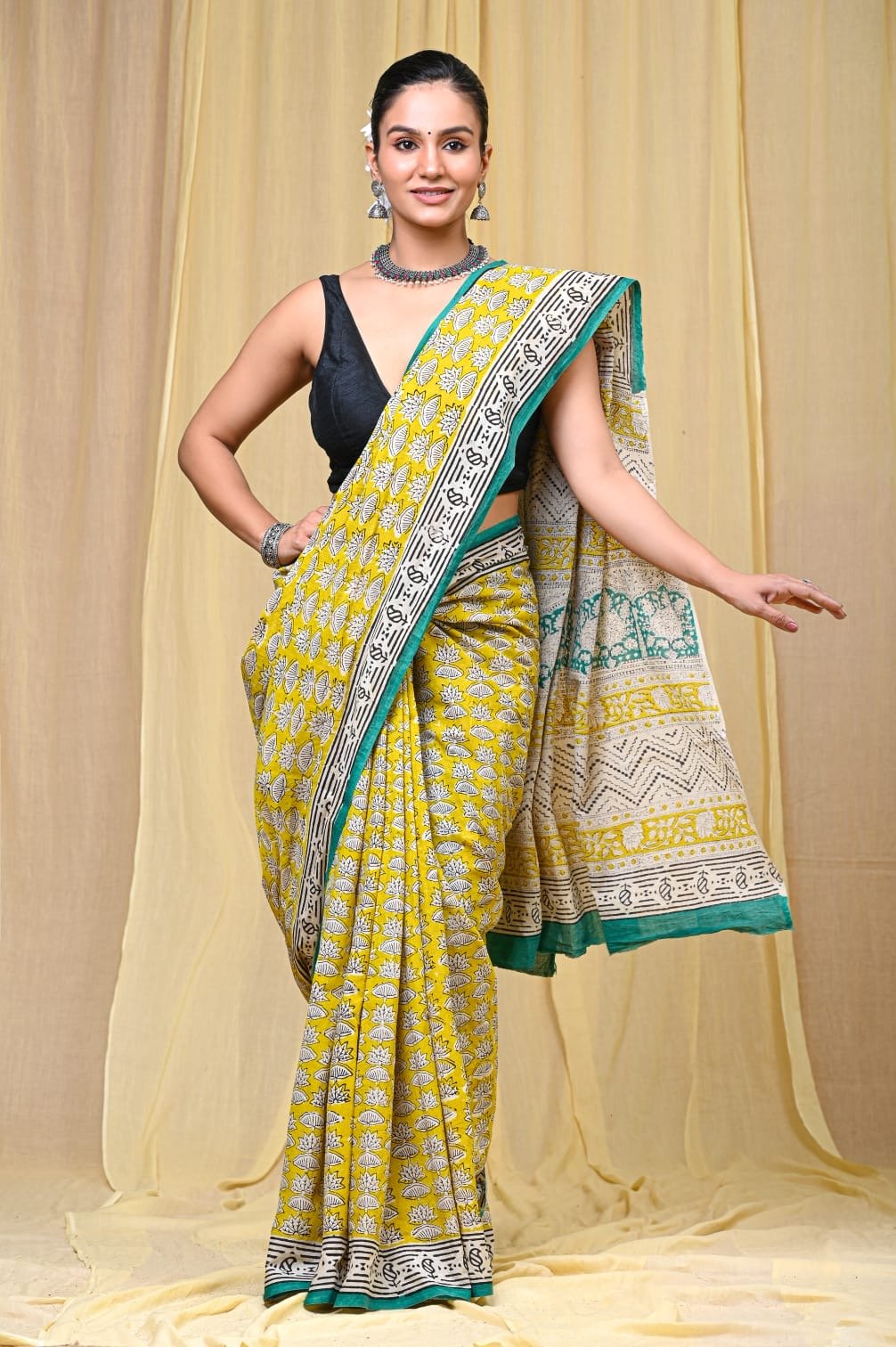 Yellow saree with floral motifs and contrasting border in traditional Bagru print