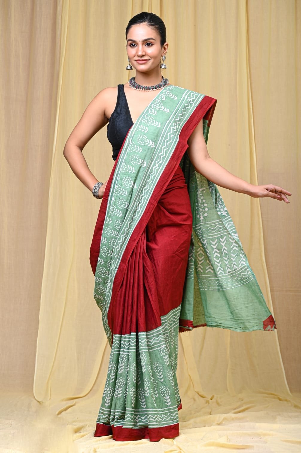 Green and red saree with floral motifs in Bagru hand block print