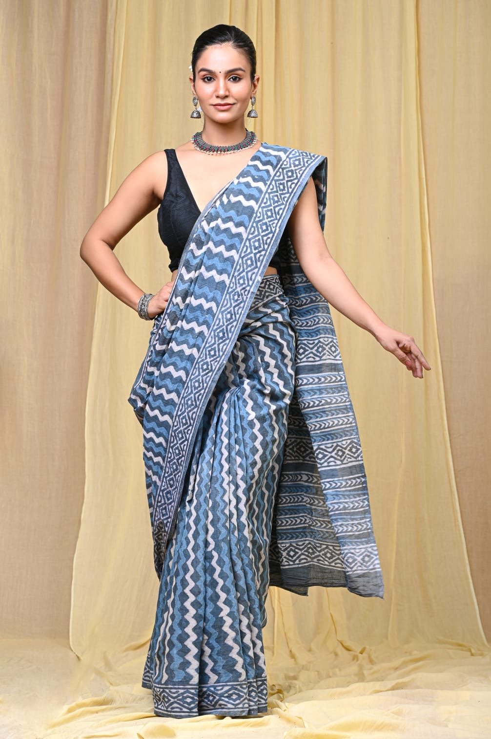 Blue saree with geometric zigzag motifs and intricate border design
