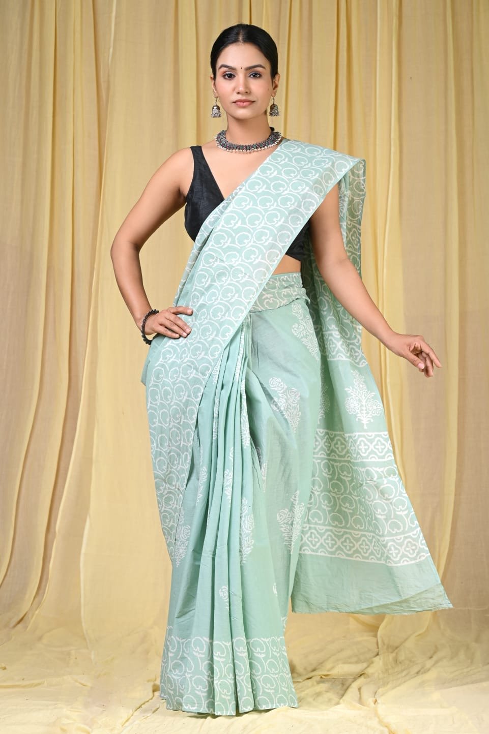 Pastel green saree with floral motifs and geometric pattern using Bagru hand block print