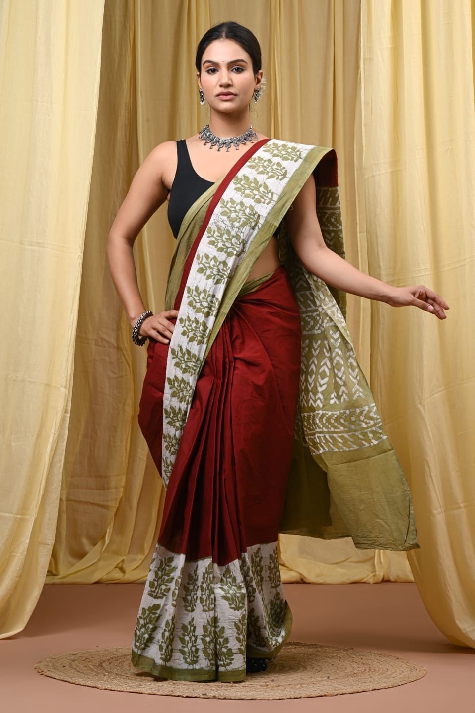 Olive green floral motifs on a maroon Bagru hand block print saree