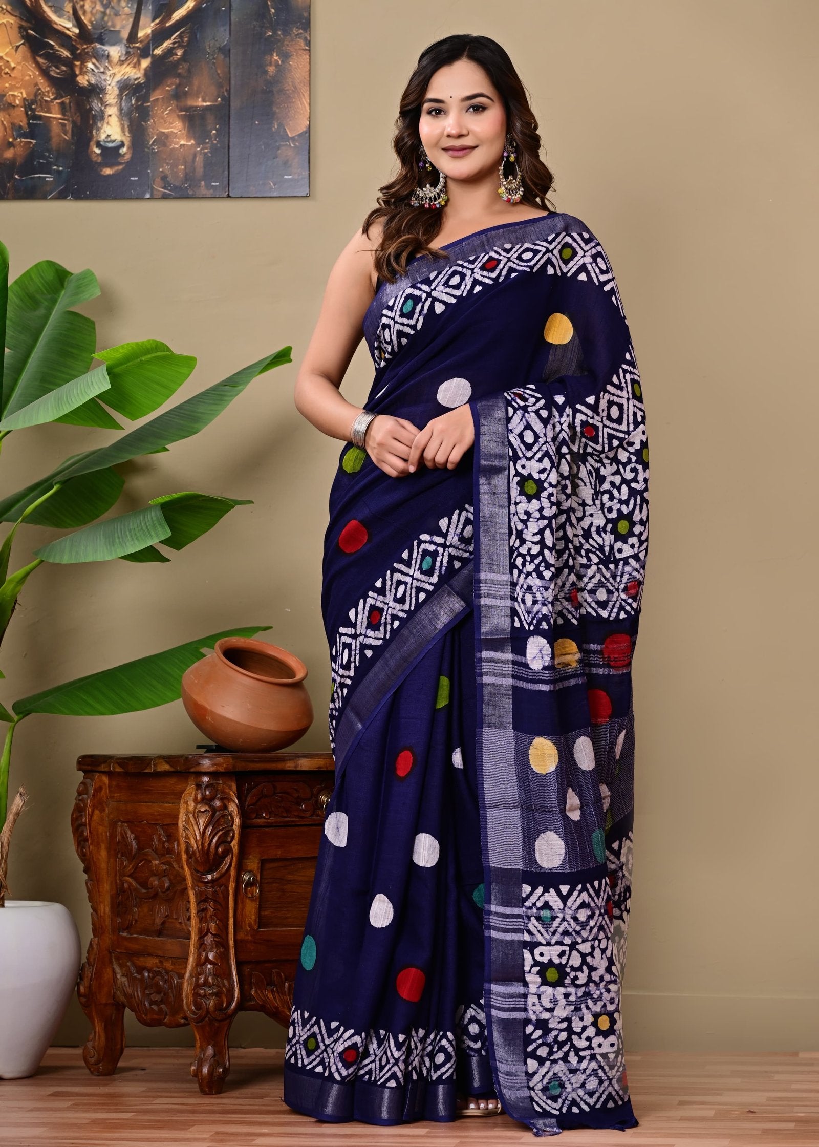 Navy blue saree with colorful polka dots, geometric patterns, and a traditional design.