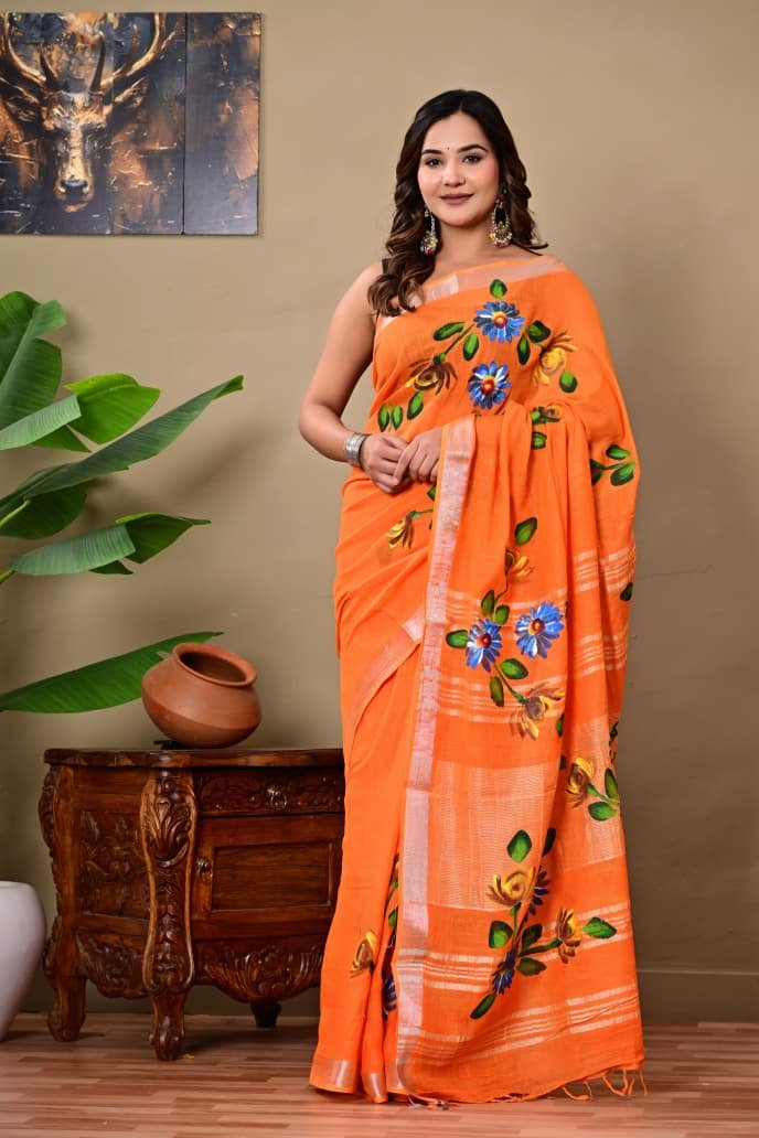 Orange saree with vibrant blue and yellow floral motifs, Bagru hand block print.