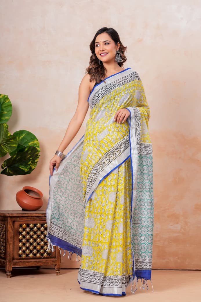 Yellow saree with floral Bagru block print, blue border, and turquoise geometric motifs