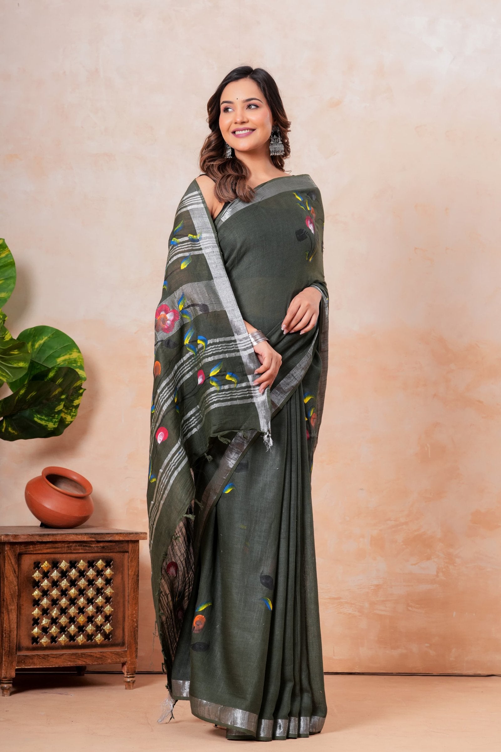 Green saree with floral motifs, silver border, and pallu in Bagru hand block print