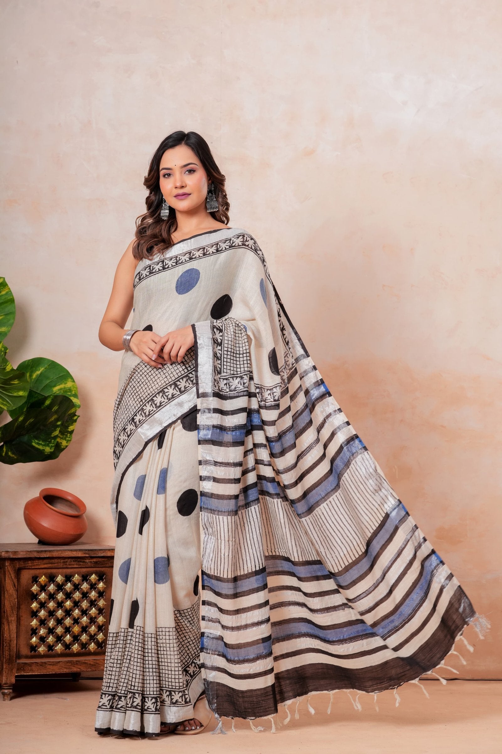 Cream saree with blue and black polka dots and floral border design