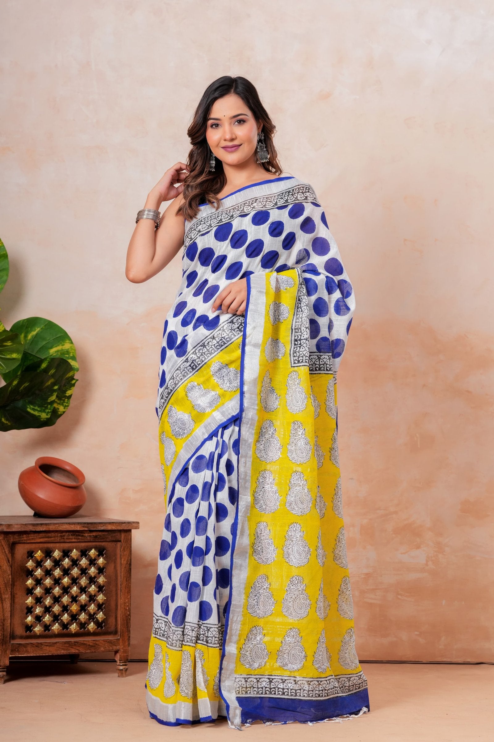 Blue polka dot and yellow buta motifs on a linen cotton saree with black and white border.