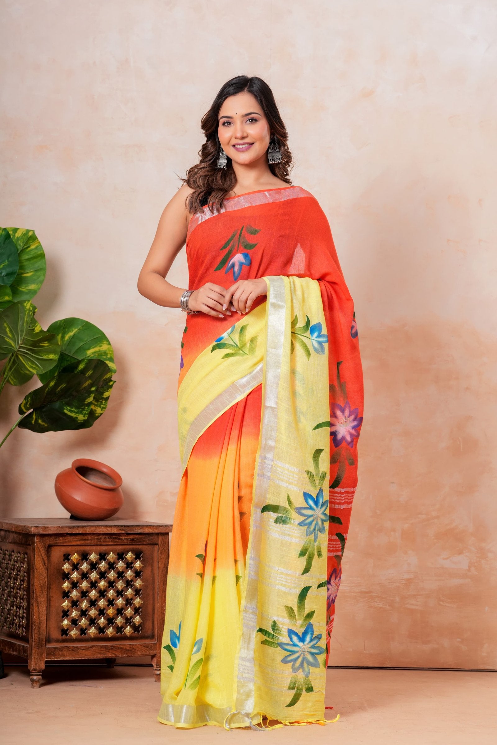 Saree with vibrant orange, yellow, and red hues and floral motifs