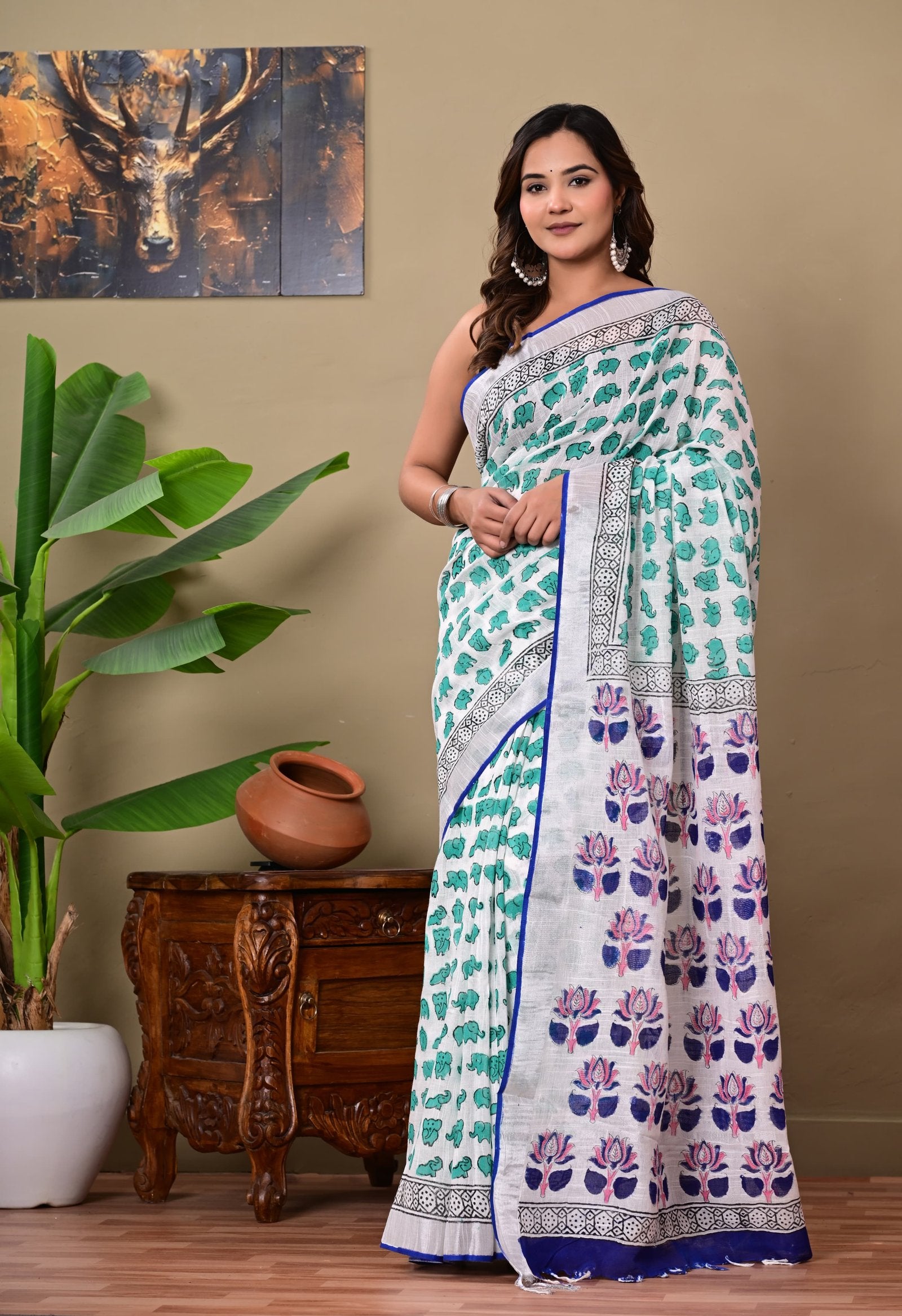 Saree with turquoise floral and elephant motifs in linen cotton fabric, hand block print