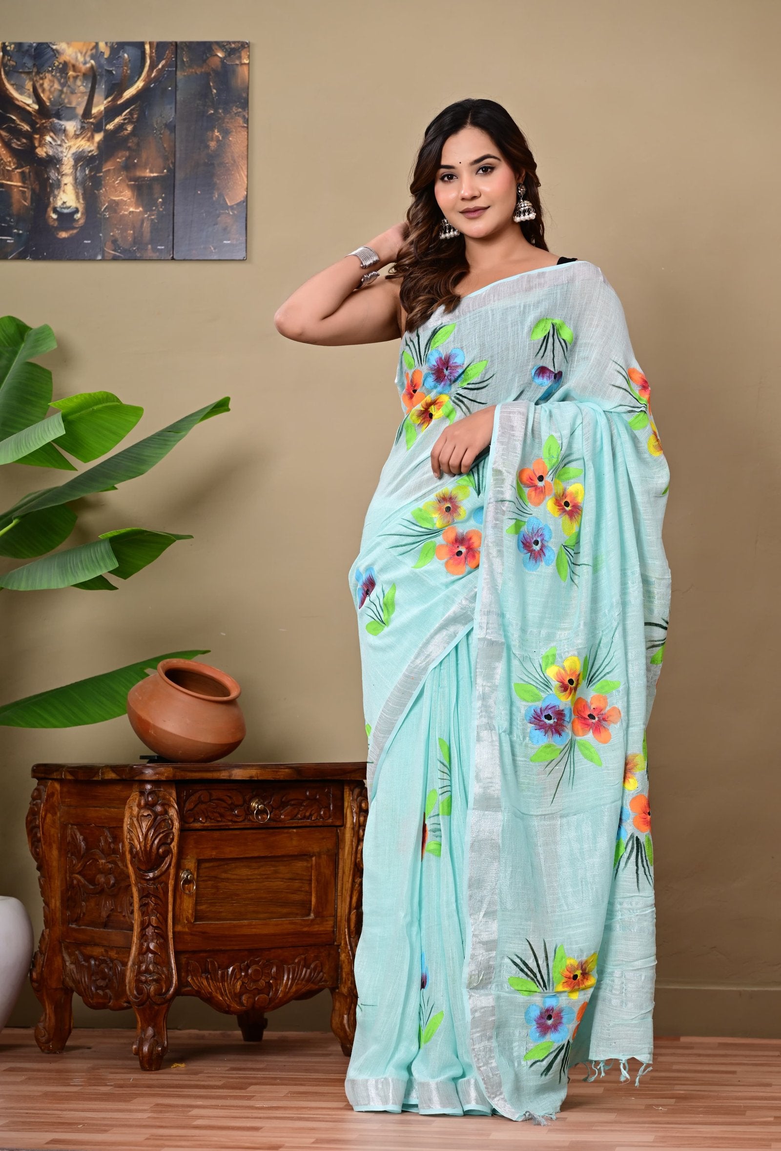 Aqua saree with vibrant floral motifs and silver border in Bagru hand block print