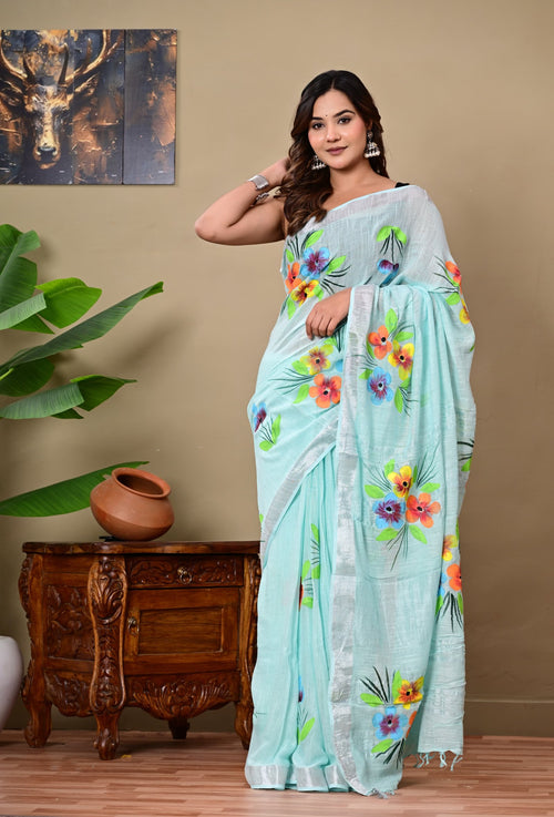 Aqua saree with vibrant floral motifs and silver border in Bagru hand block print