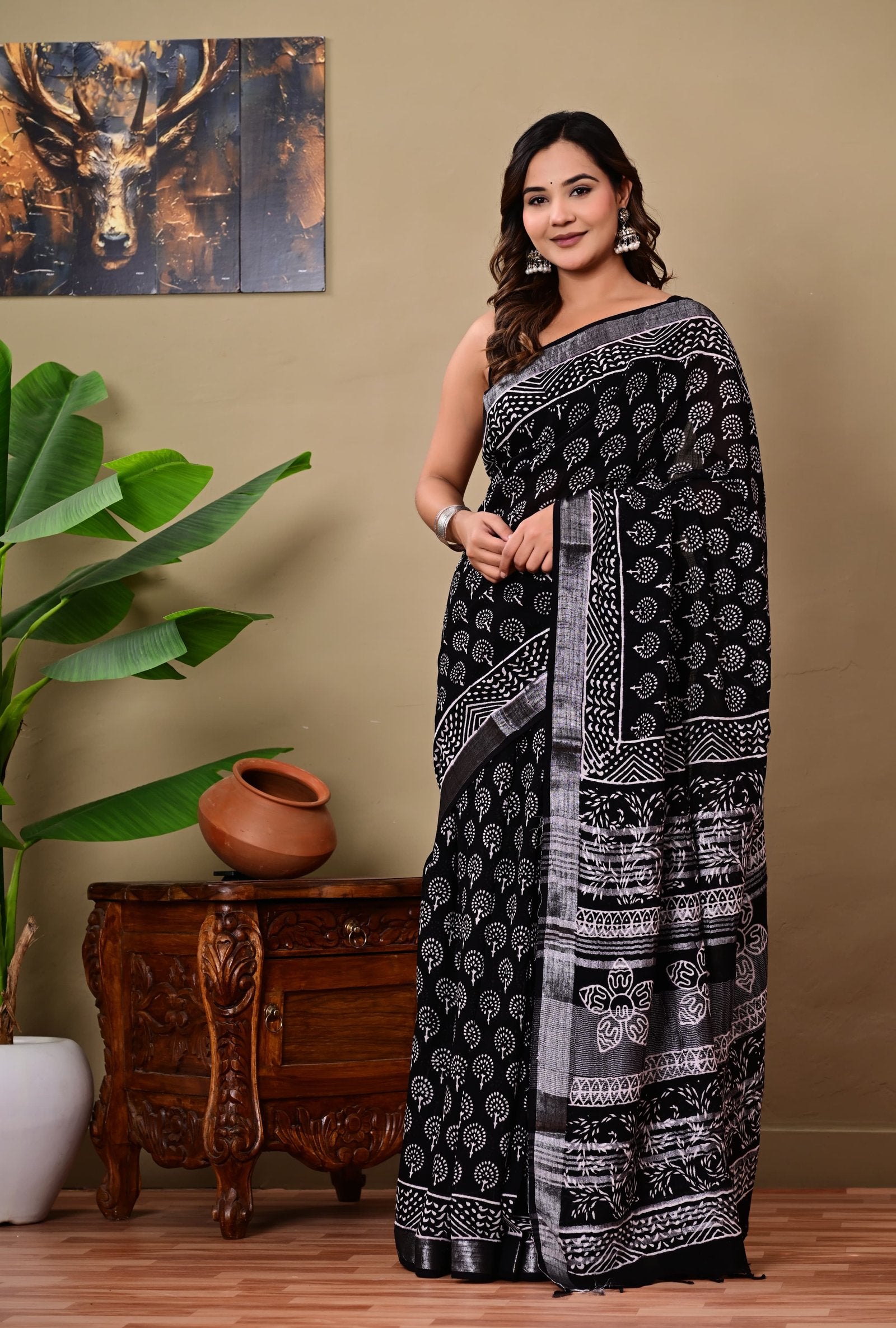 Black saree with white floral and geometric Bagru prints, elegantly draped