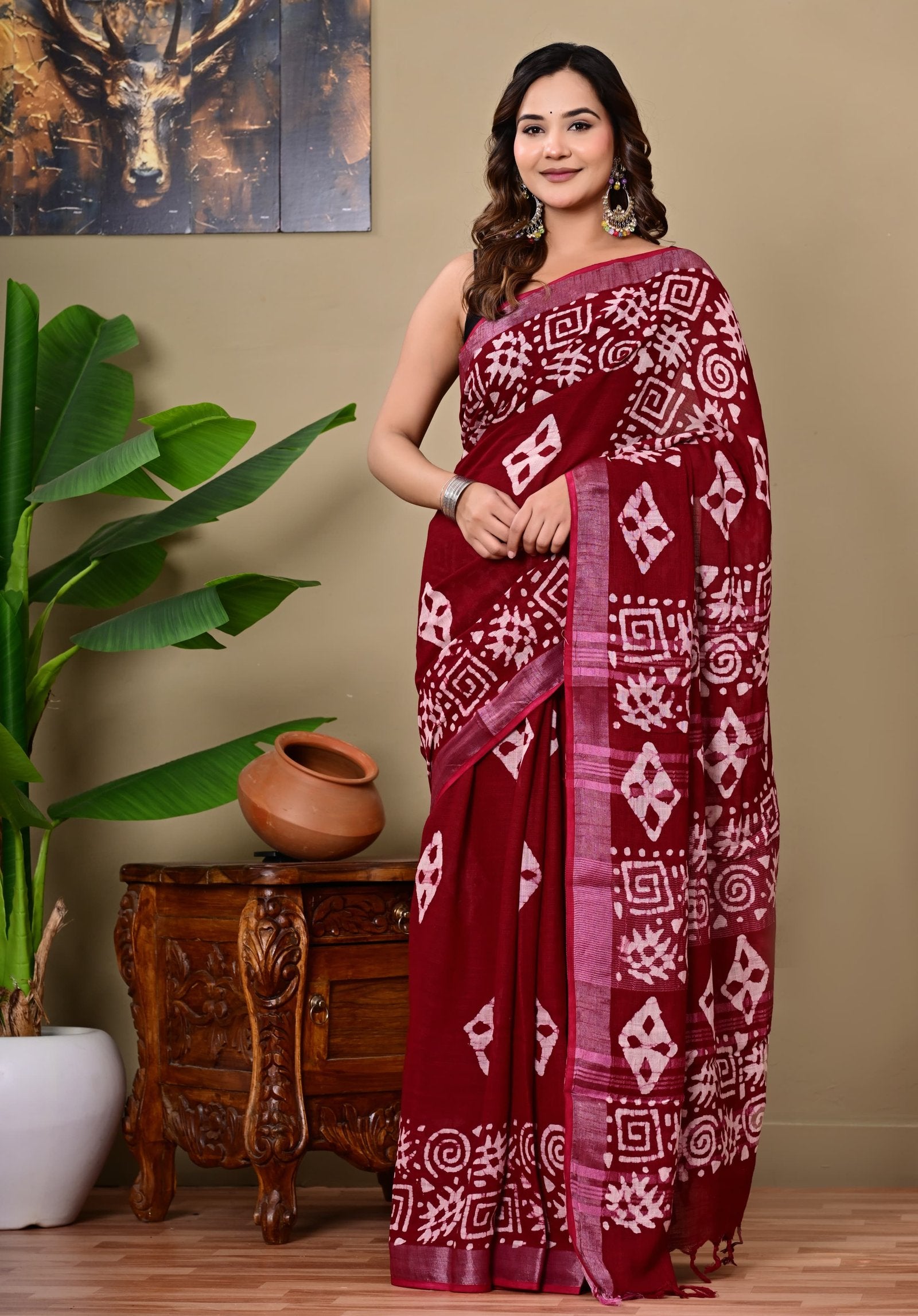 Saree showing maroon color with white geometric block print motifs