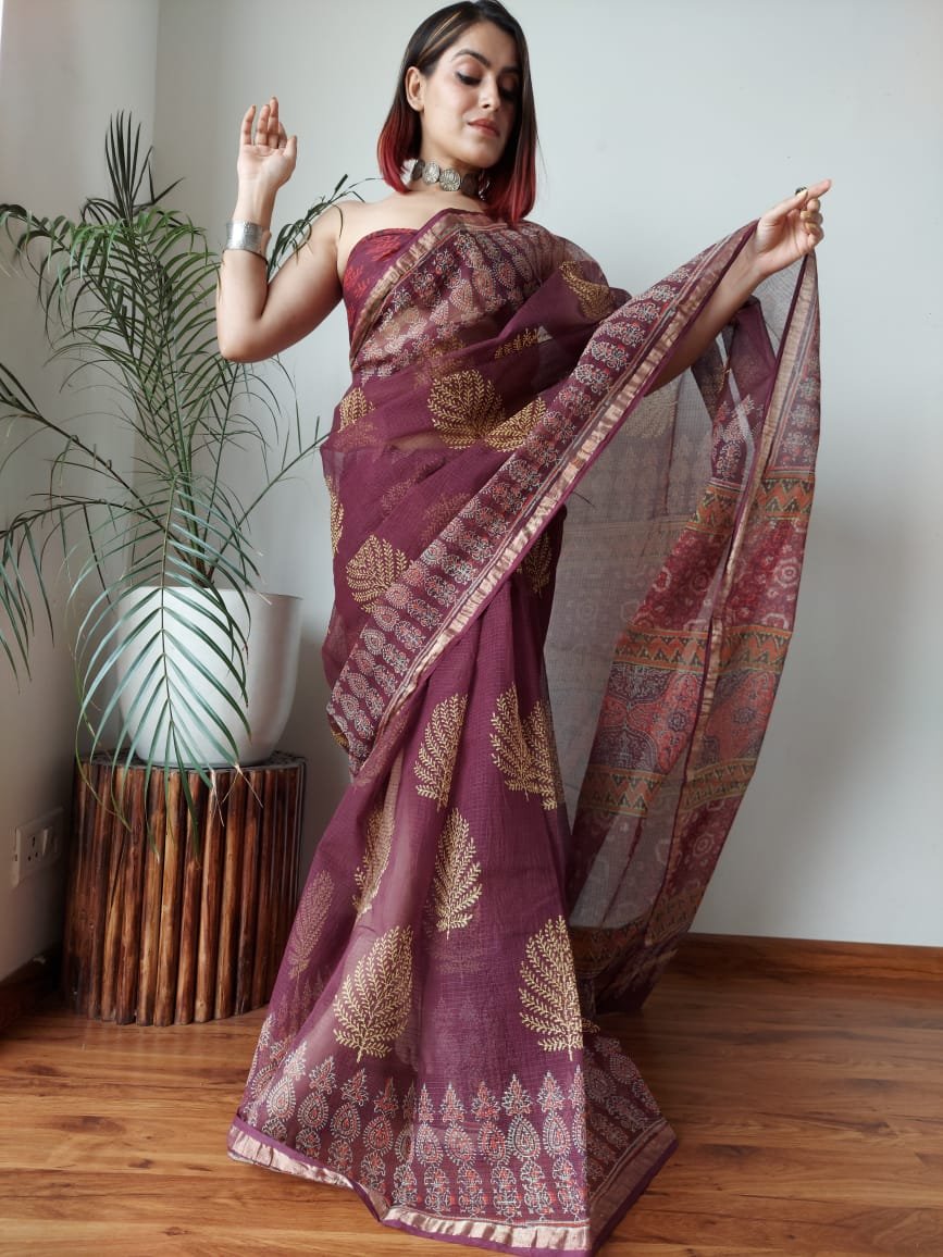 Maroon saree with gold floral motifs and intricate border design