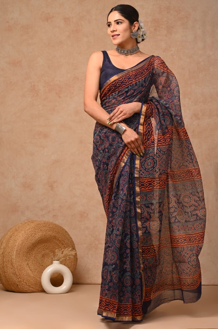 Navy blue and orange saree with floral and geometric motifs in Bagru hand block print