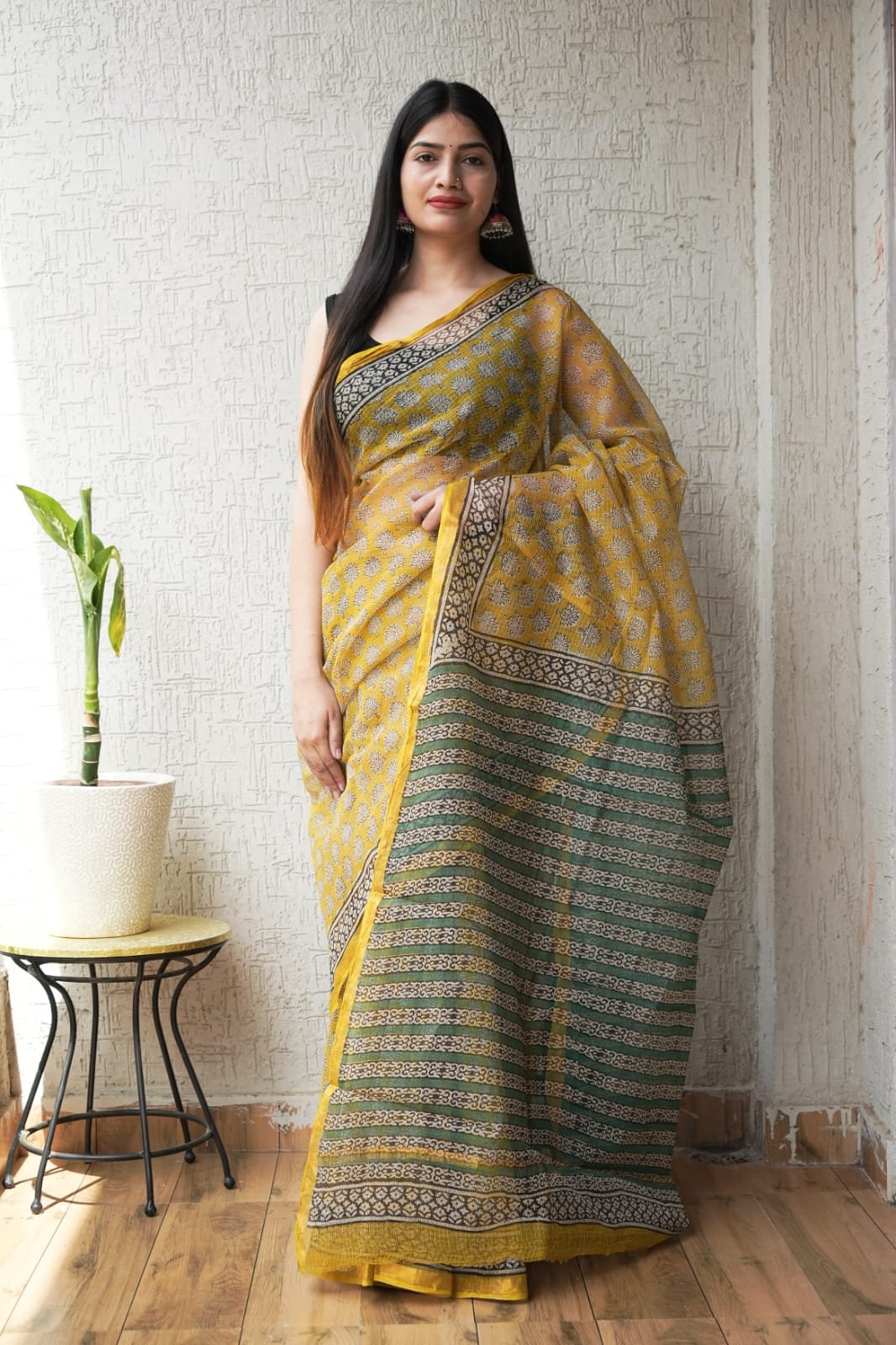 Yellow Kota Doriya saree with floral motifs and geometric border designs
