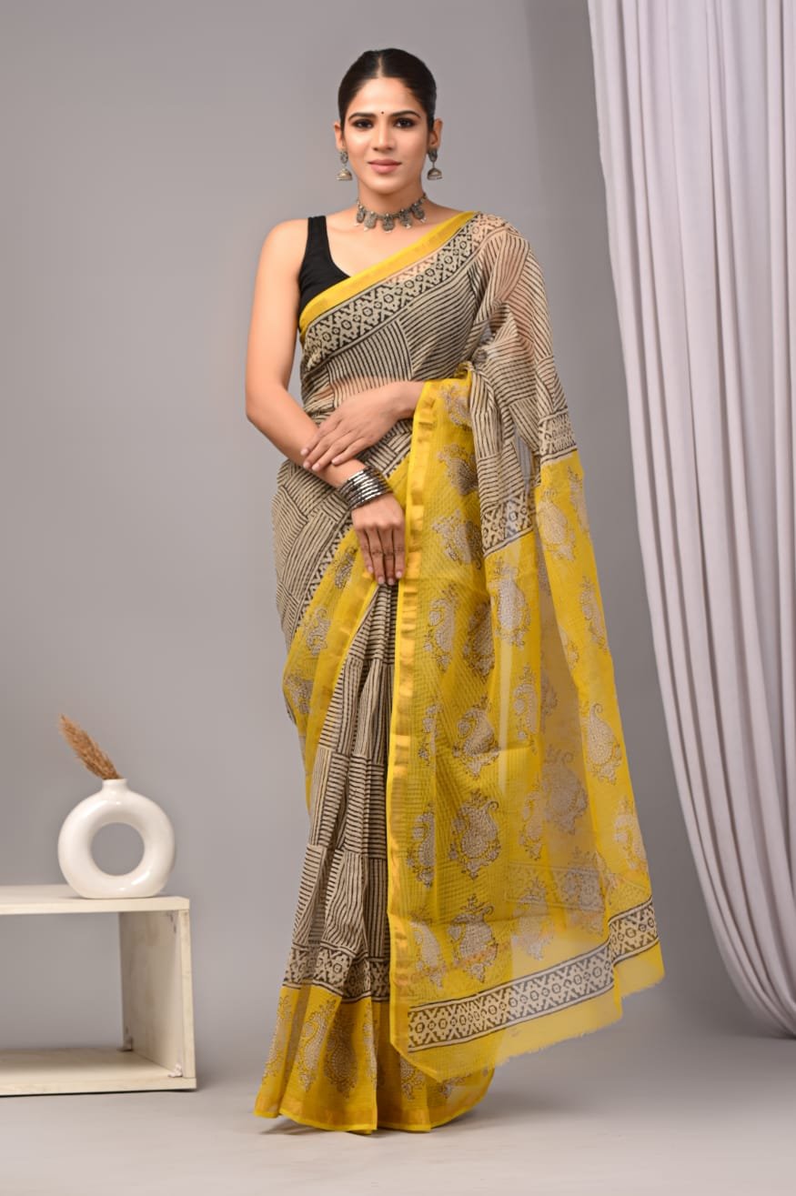 Yellow saree with paisley motifs and intricate border design