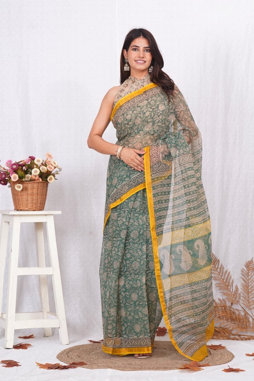 Green saree with floral Bagru prints and yellow border design.