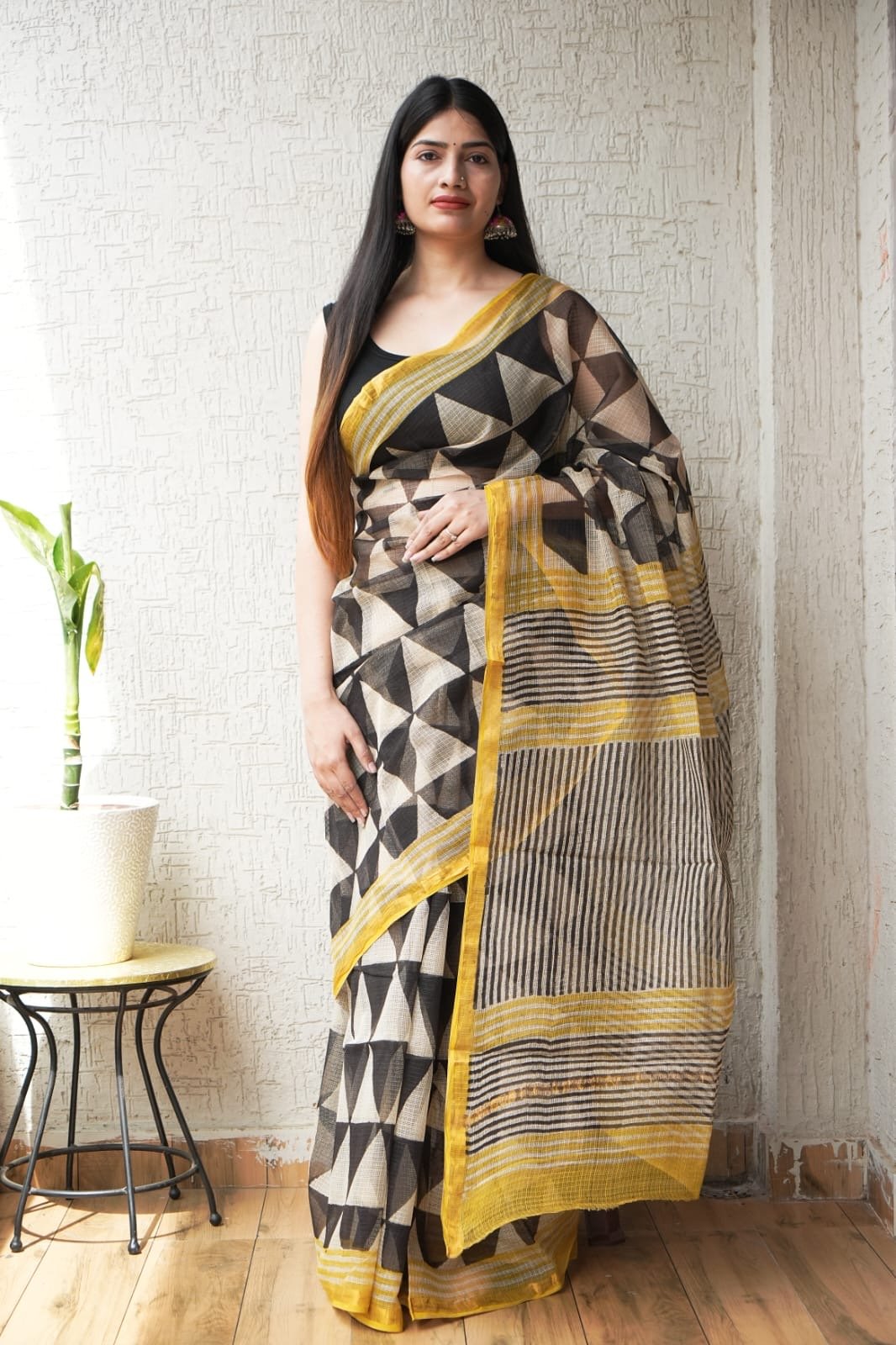 Black and yellow saree with geometric patterns and striped border