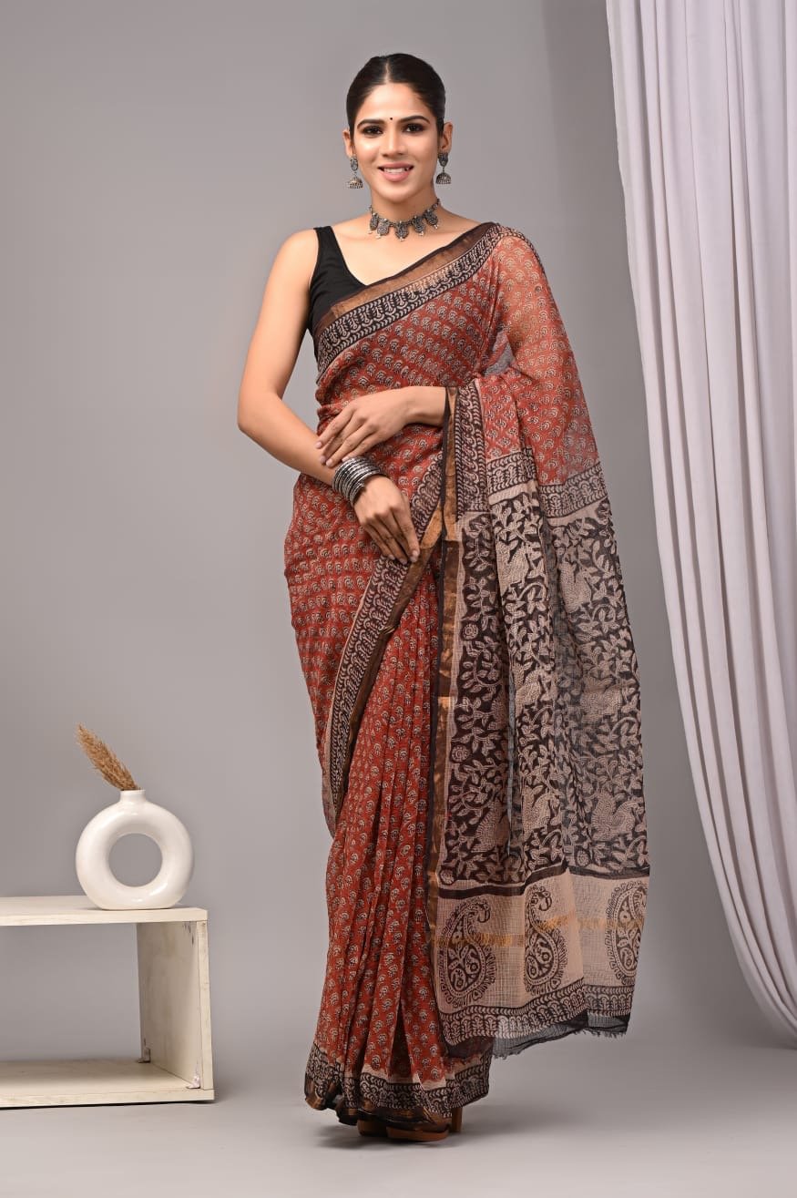 Rust and cream saree with floral motifs and intricate border patterns