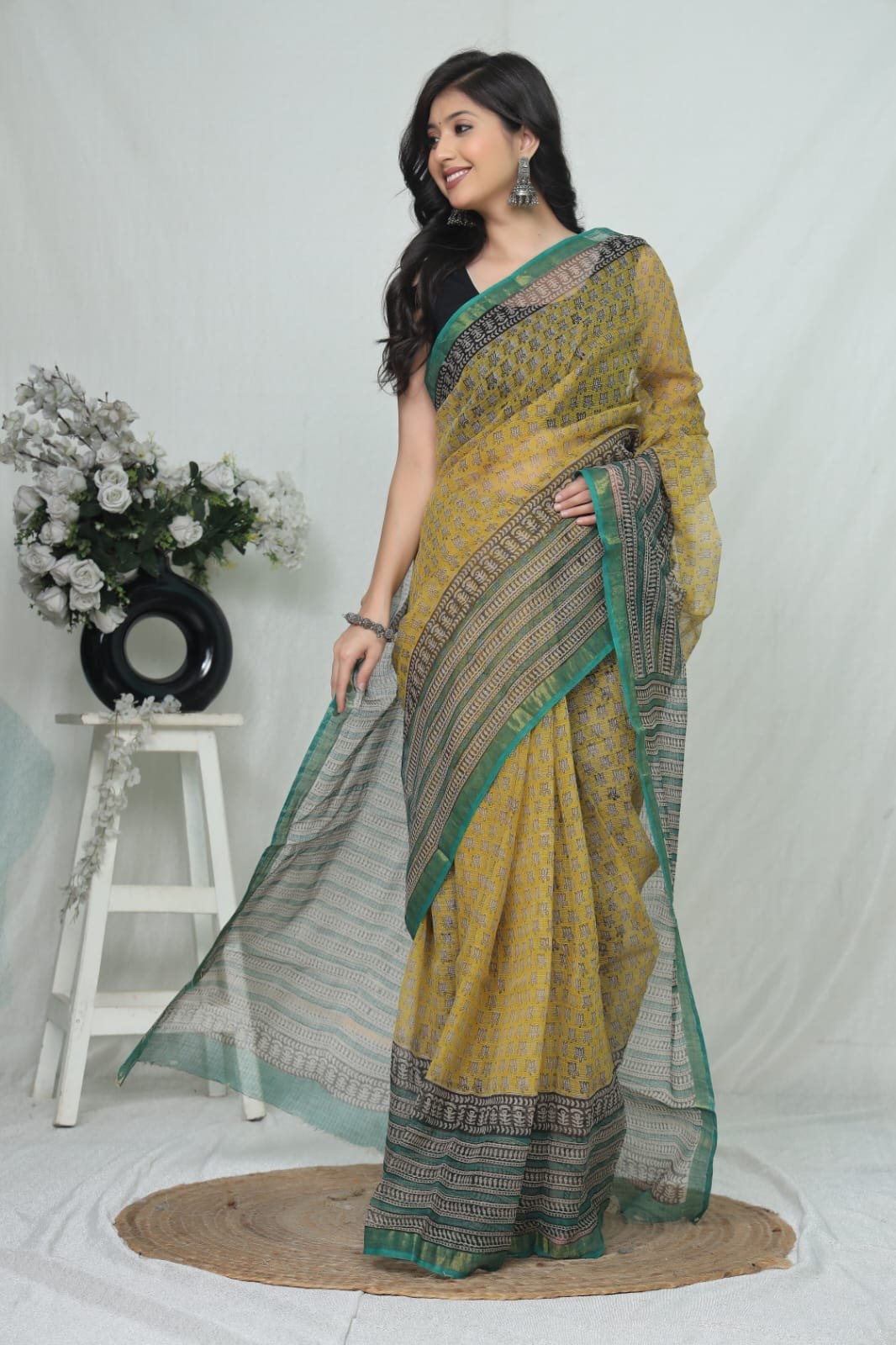 Yellow and green Kota Doriya saree with floral motifs and geometric border
