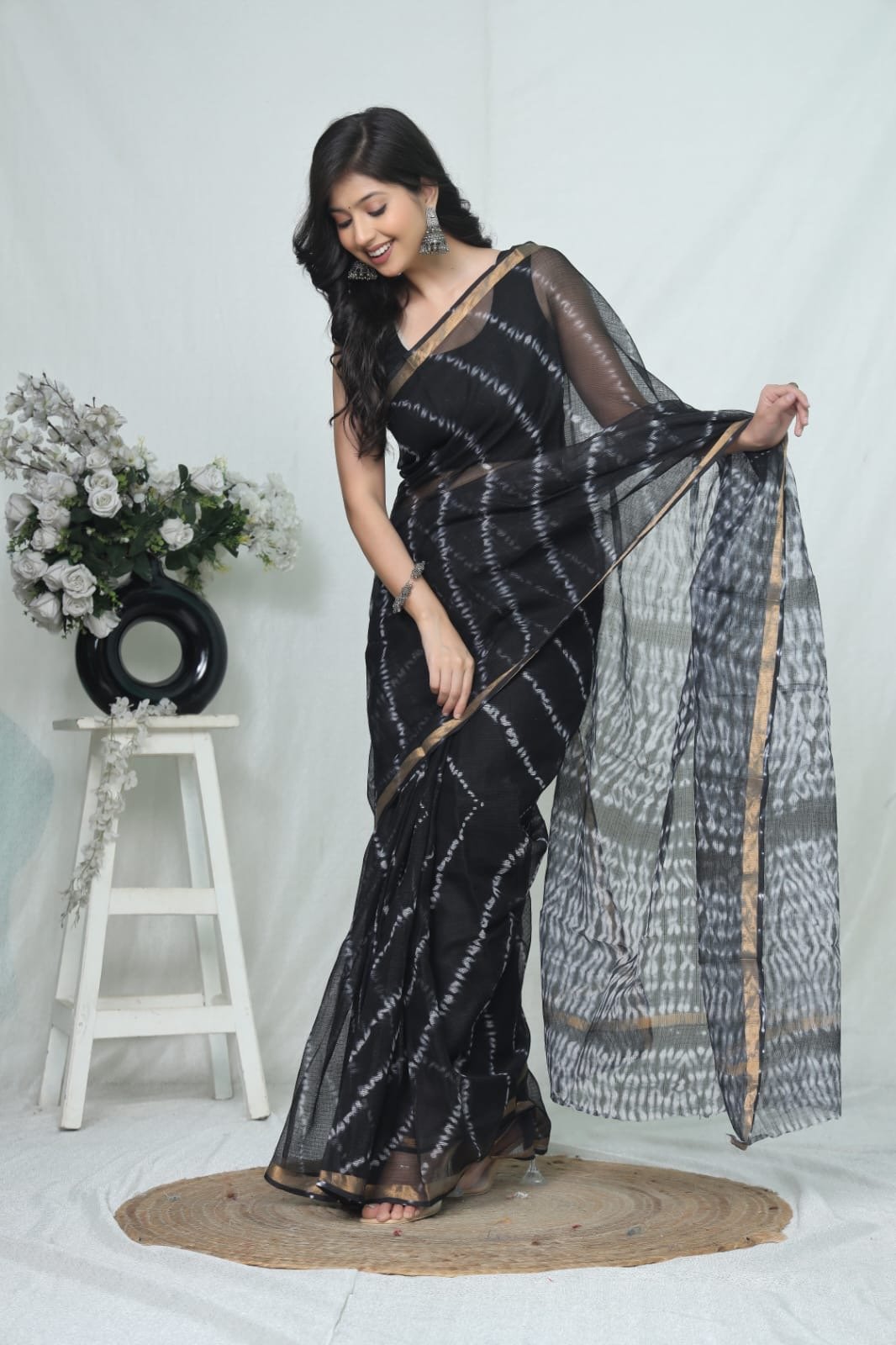 Black saree with white geometric motifs and gold border, Kota Doriya fabric