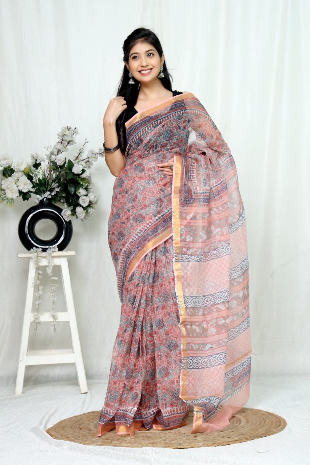 Peach saree with floral motifs and traditional Bagru hand block print