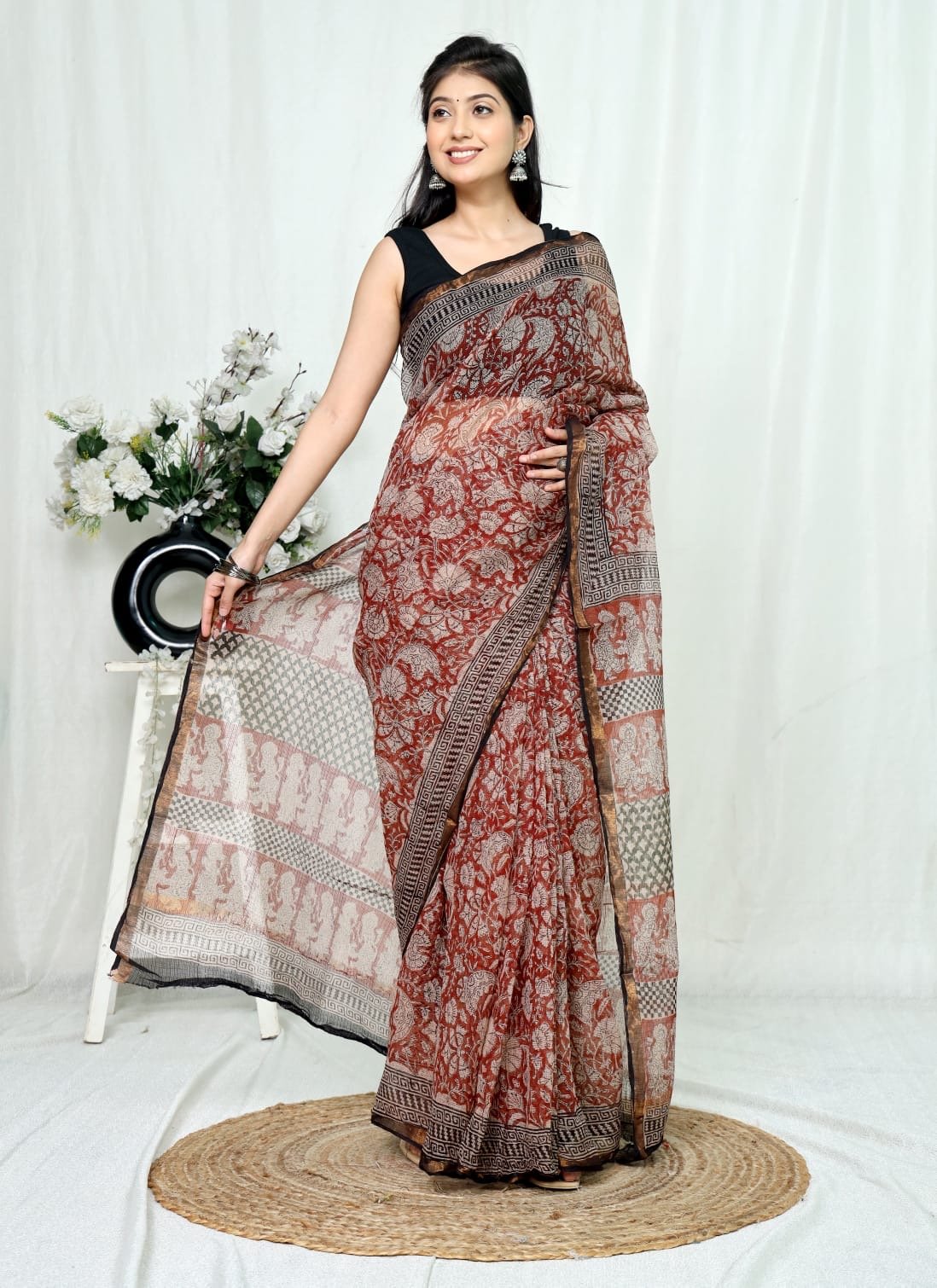 Maroon floral pattern saree with black geometric border in Kota Doriya silk