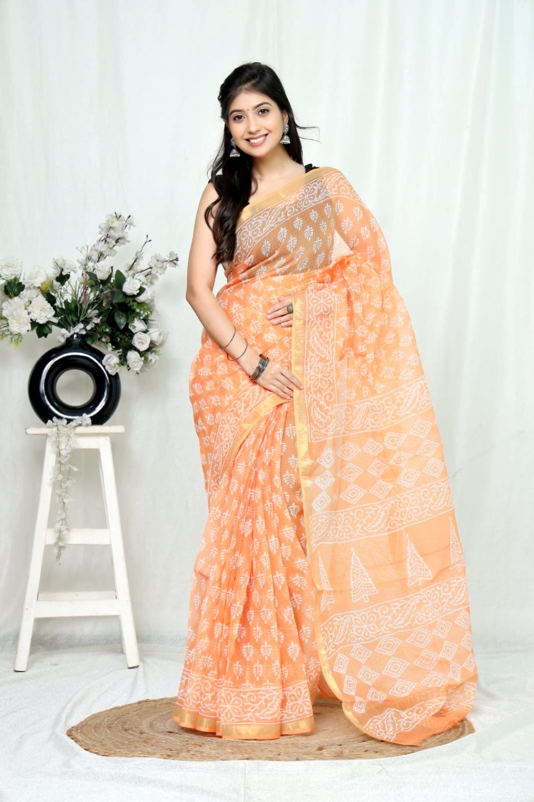 Peach Kota Doriya saree with white floral and geometric motifs