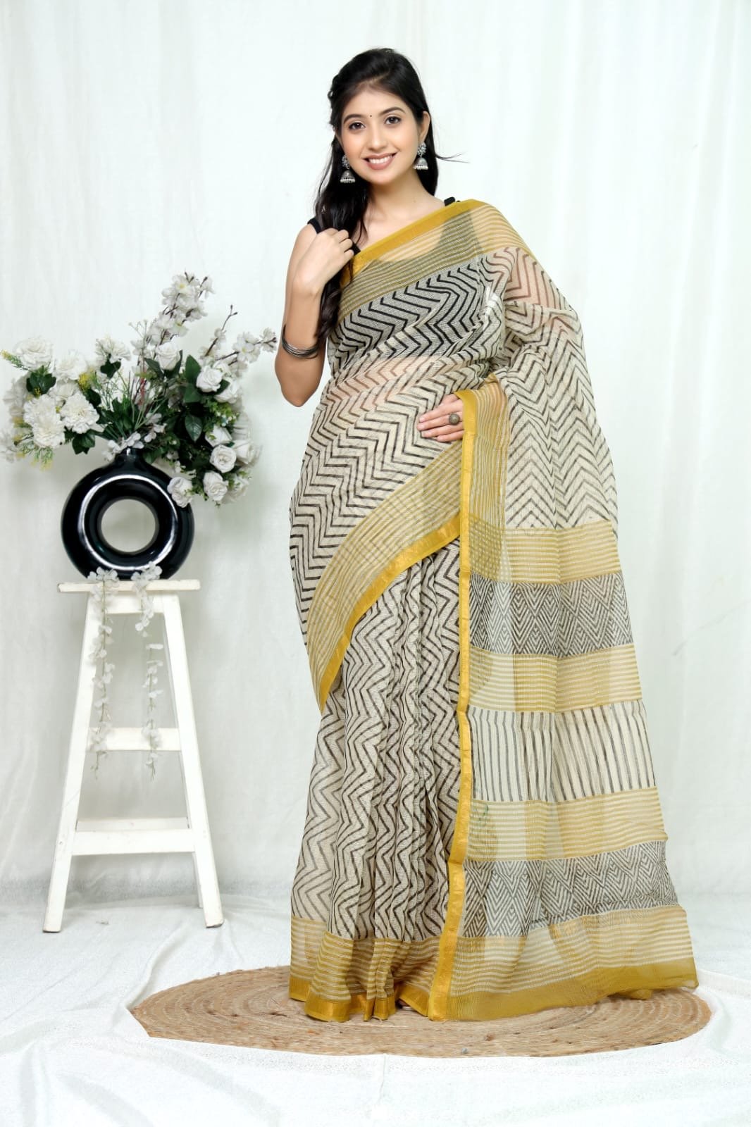 Black and gold chevron patterned Kota Doriya silk saree on white background