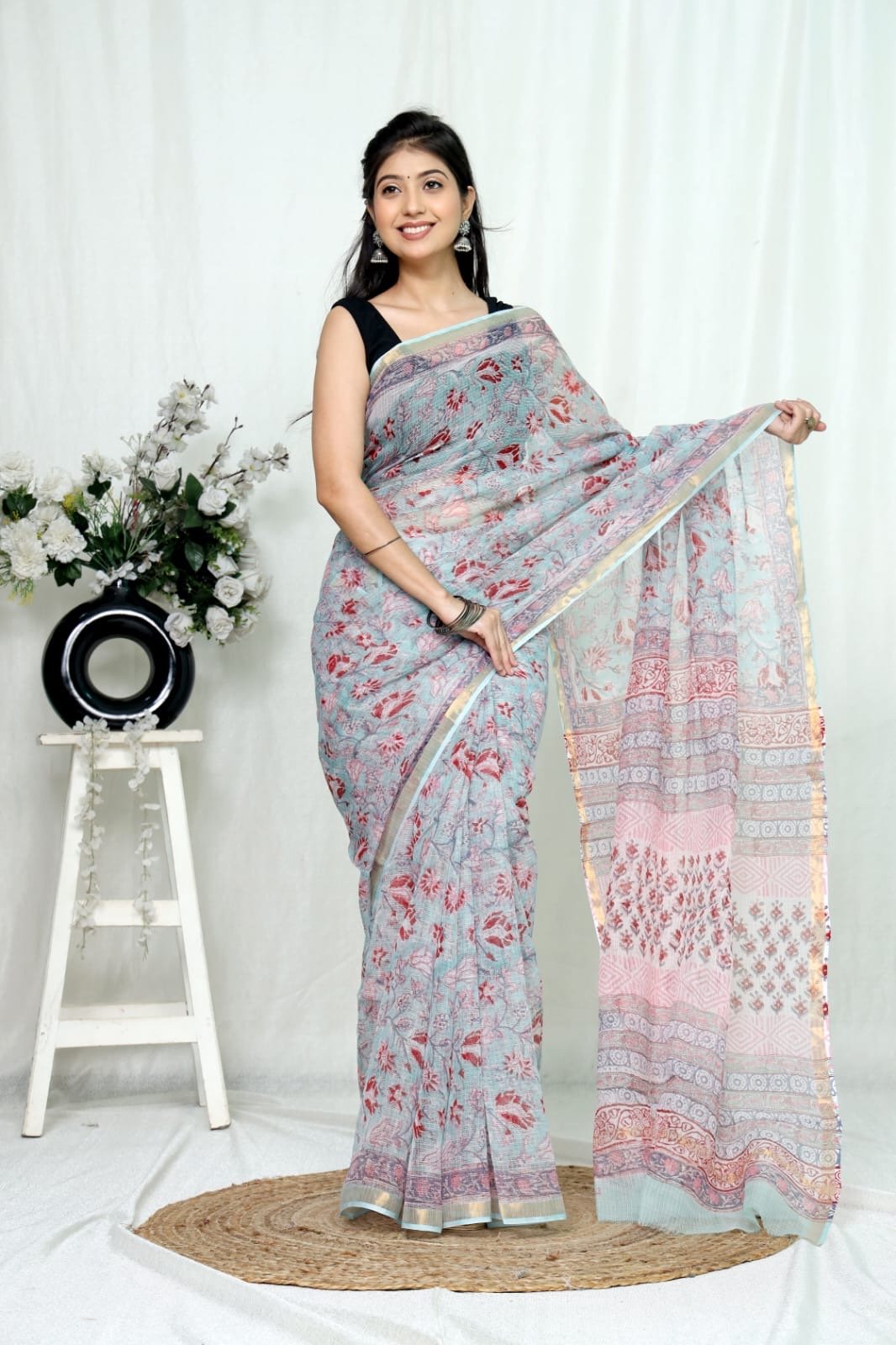 Pastel blue saree with floral motifs and intricate border design