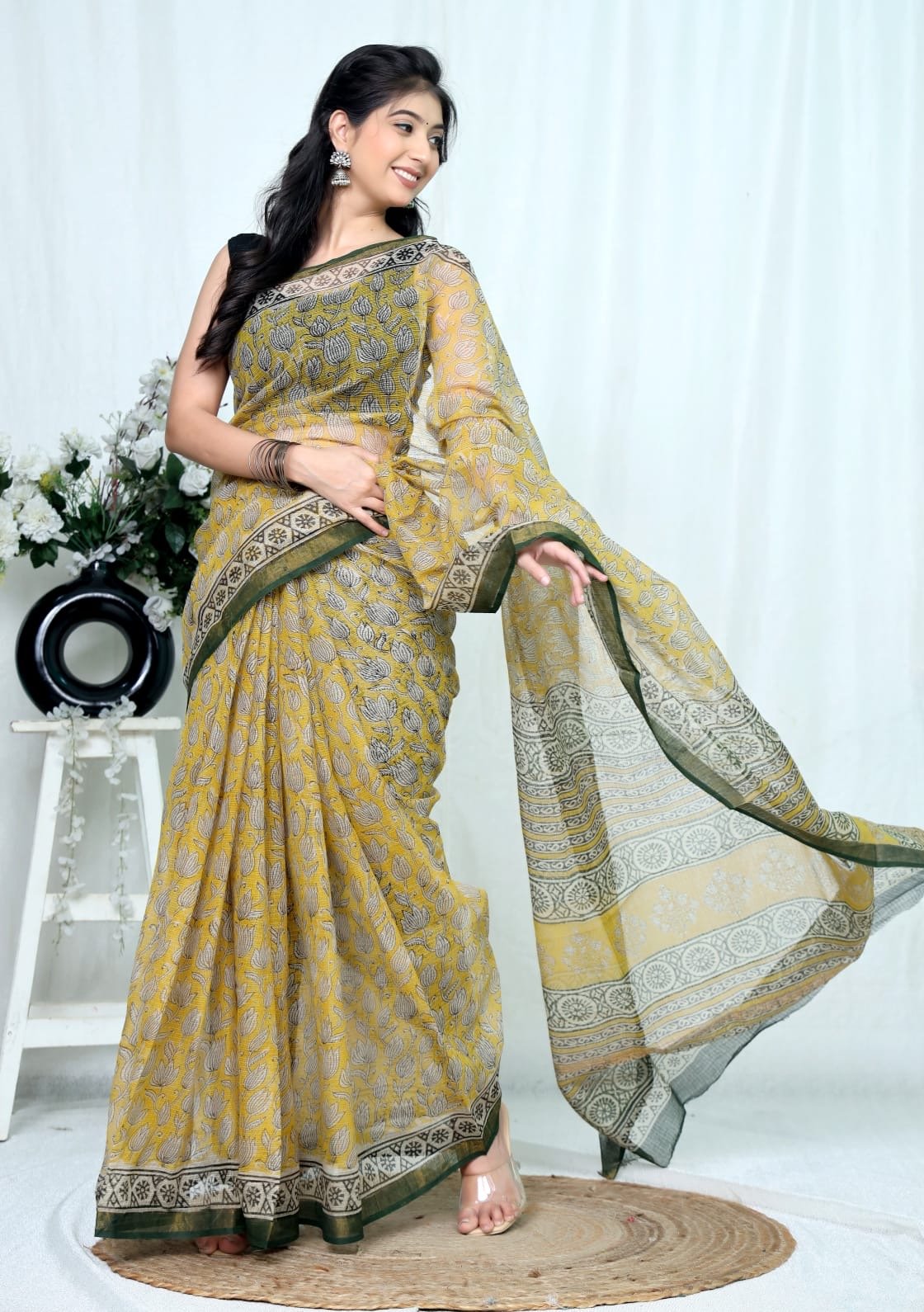 Yellow saree with floral motifs and green border in Kota Doriya fabric
