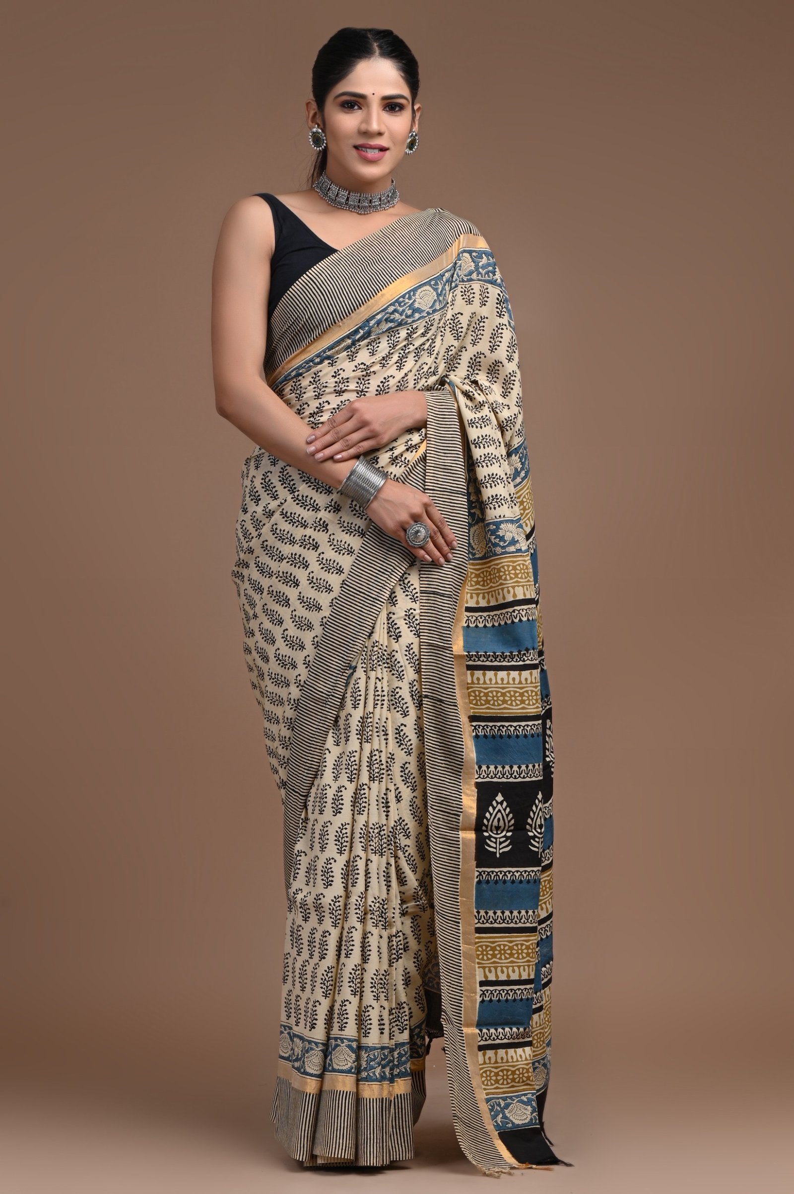 Beige and blue floral hand block print Assam silk saree with bold borders