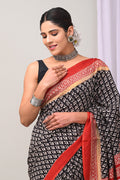 Black saree with red floral hand block print and red border design