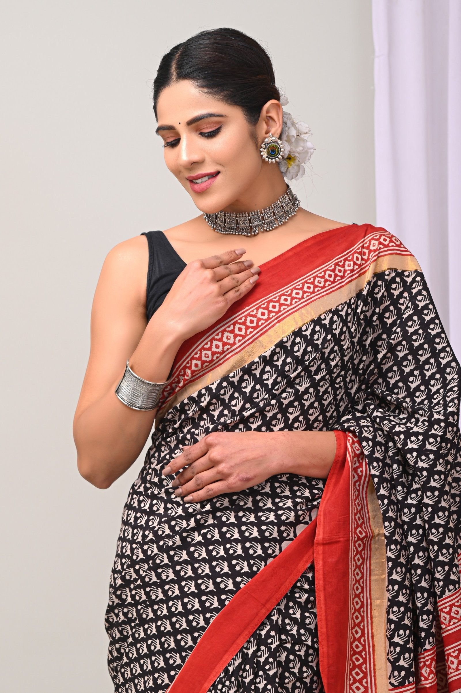 Black saree with red floral hand block print and red border design
