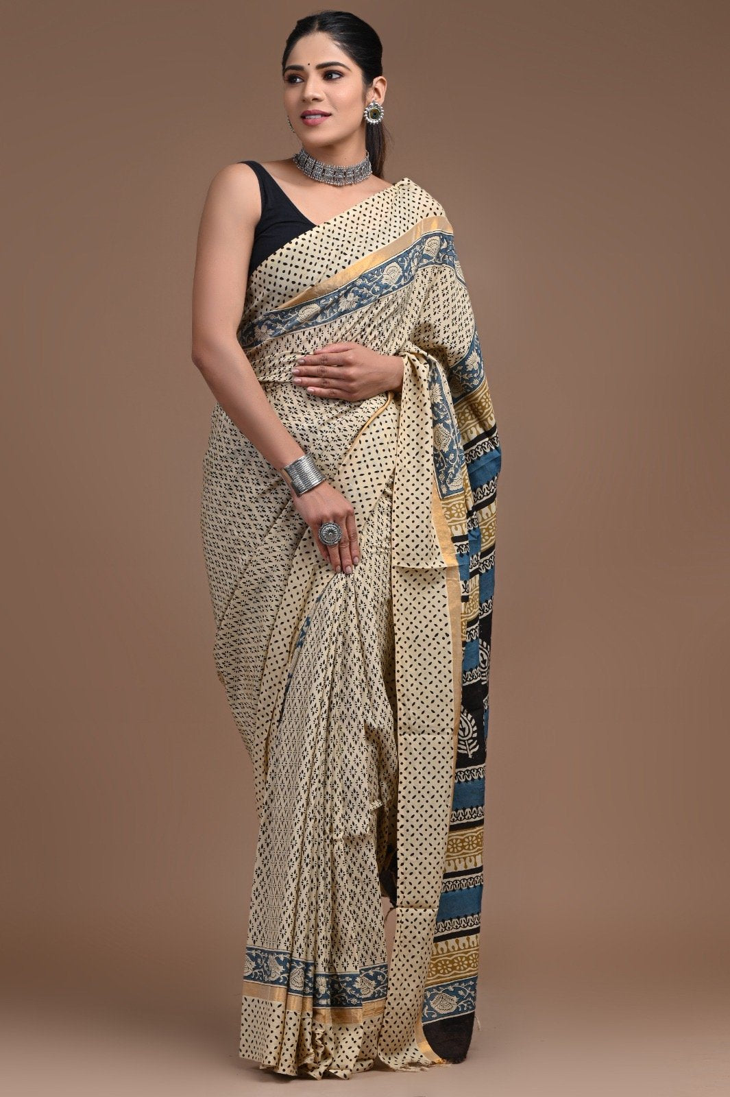 Saree with indigo floral and geometric motifs on beige background