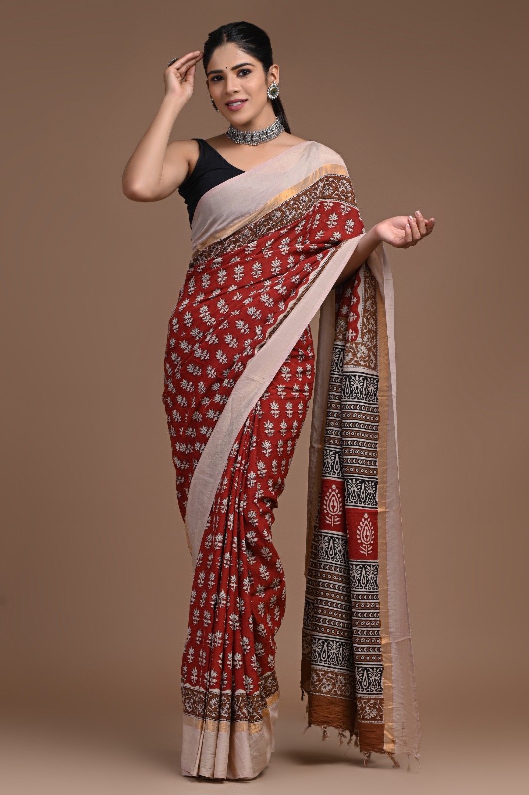 Maroon saree with floral buta motifs and detailed border