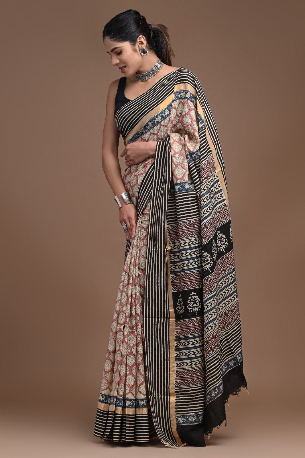 Beige and black saree with floral buta motifs and geometric patterns