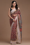 Red saree with floral motifs and geometric patterns featuring a luxurious border