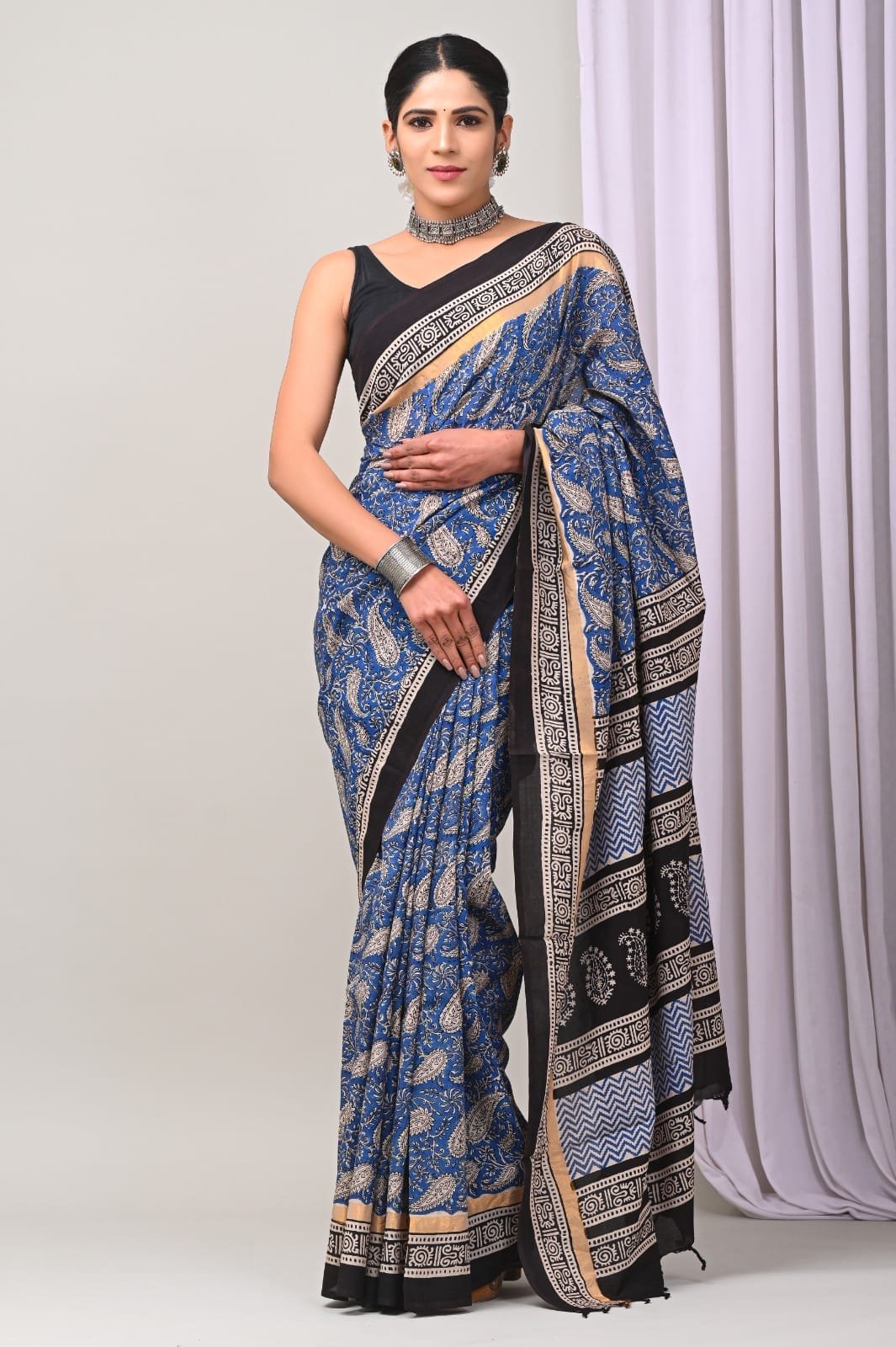 Blue saree with paisley motifs and geometric border in Assam Silk fabric