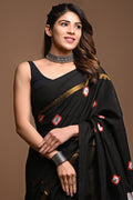 Black saree with geometric red and gold motifs, hand block printed design