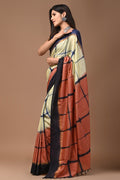 Cream and rust saree with geometric block print motif and soft sheen