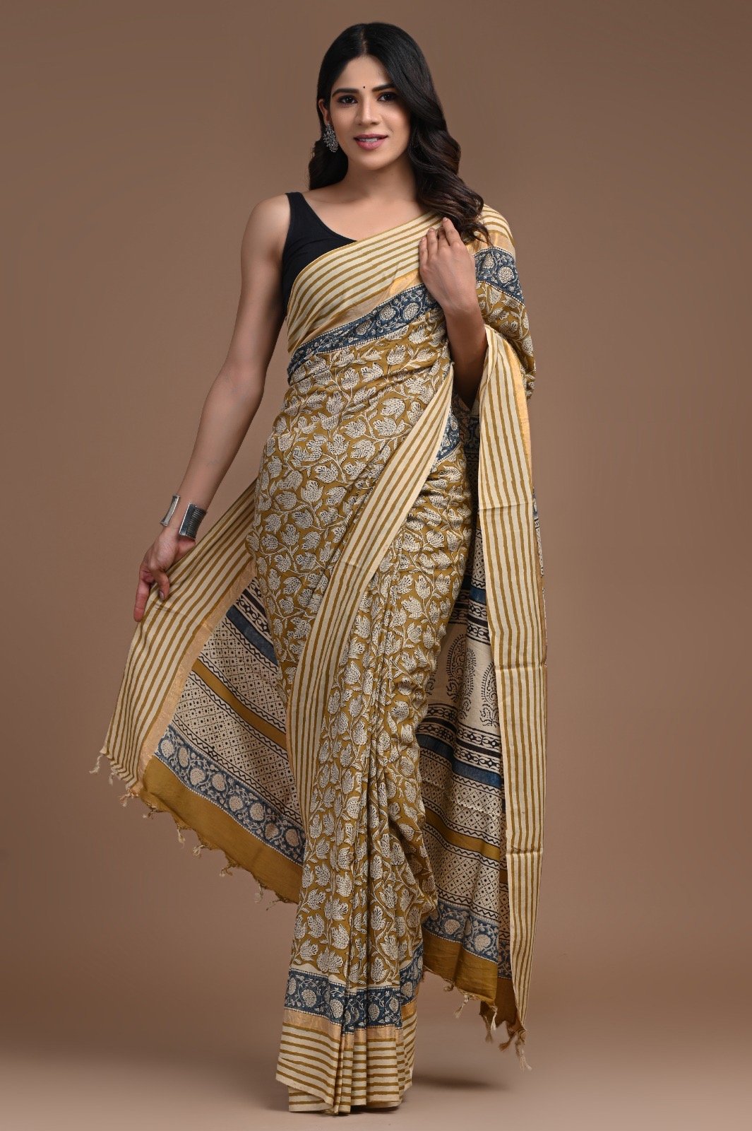 Gold and indigo saree with intricate floral hand block print and striped border.
