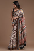 Ivory and maroon saree with floral jaal and geometric patterns, handcrafted detailing