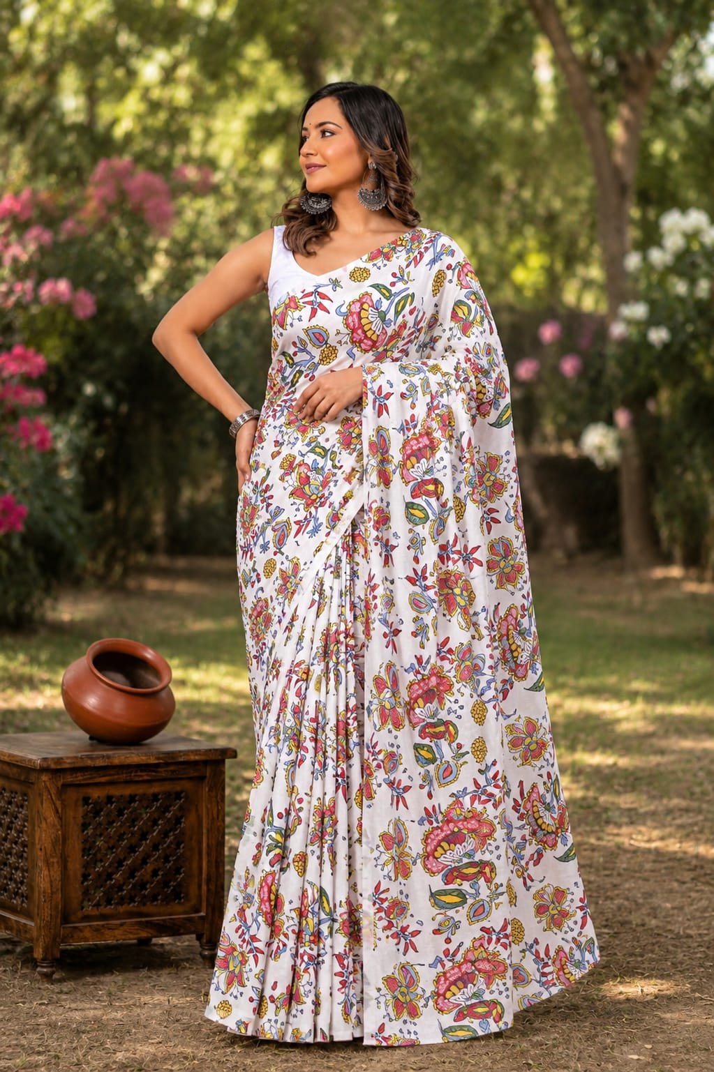 Saree with multicolor floral motifs against a white background, hand block printed