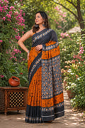 Orange and black saree with floral motifs and intricate border design