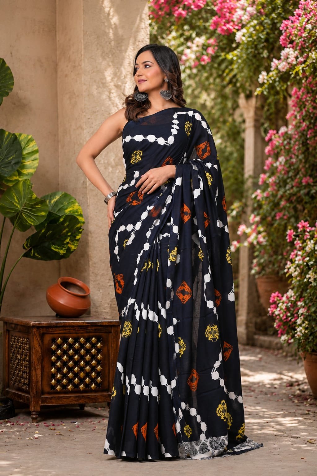 Navy blue saree with geometric motifs in white, red, and yellow