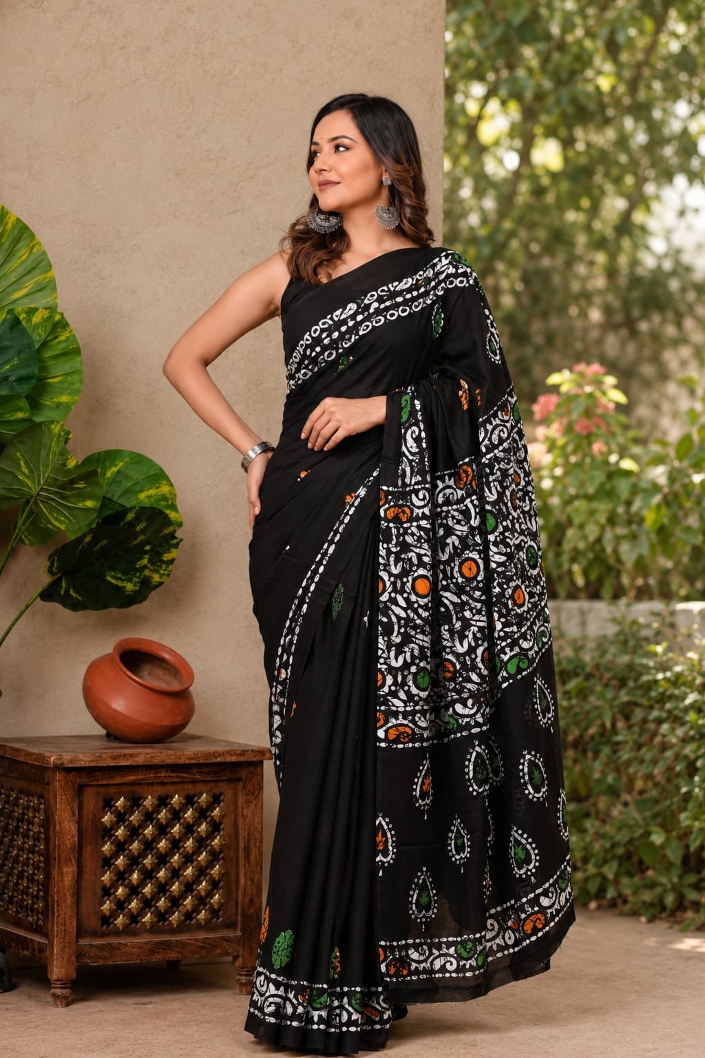Black Mul Cotton saree with white paisley motifs and orange-green accents